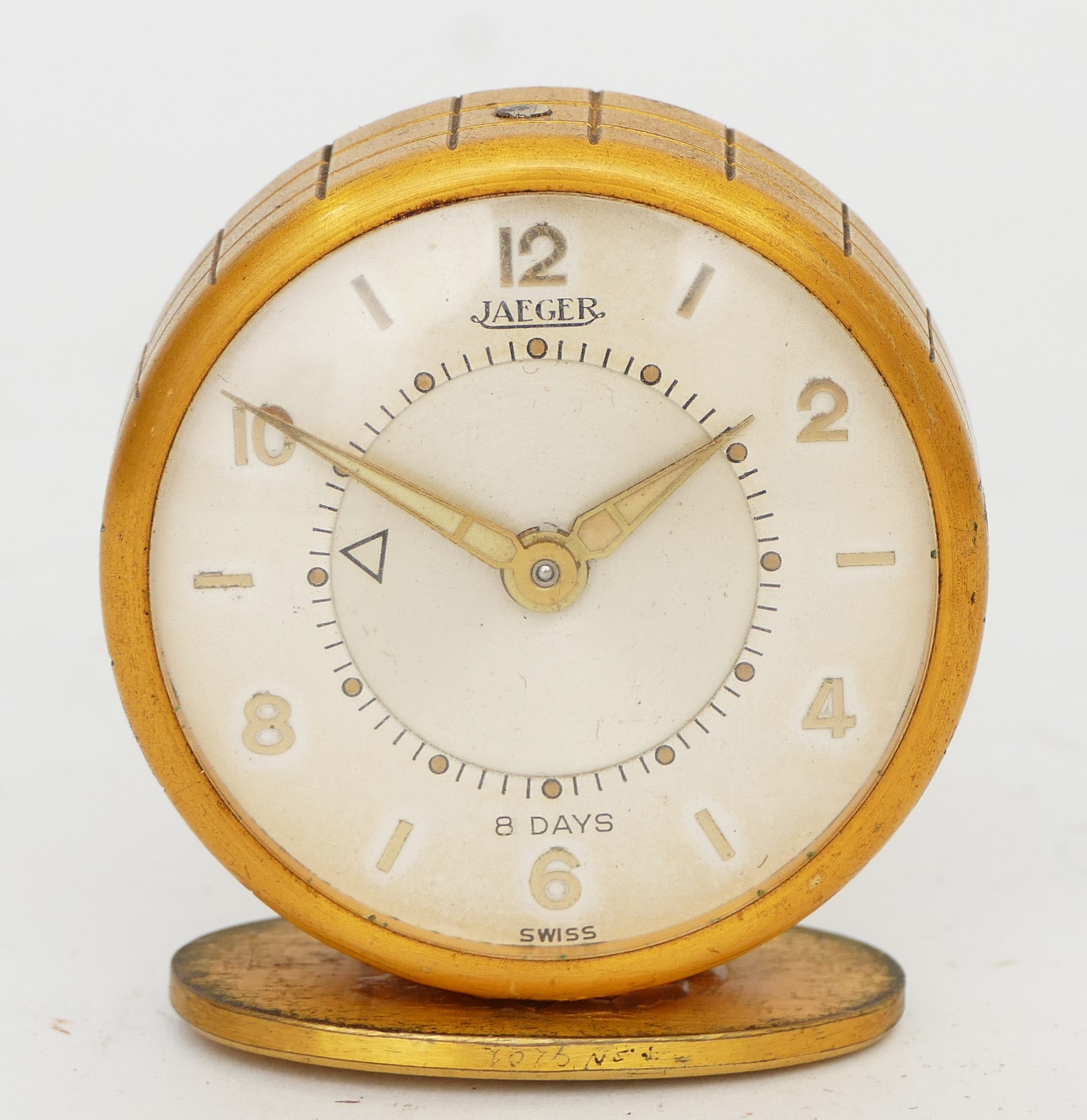 Jaeger, a gilt metal 8 day travel alarm clock, model 51, mounted on a stand, with original 1956
