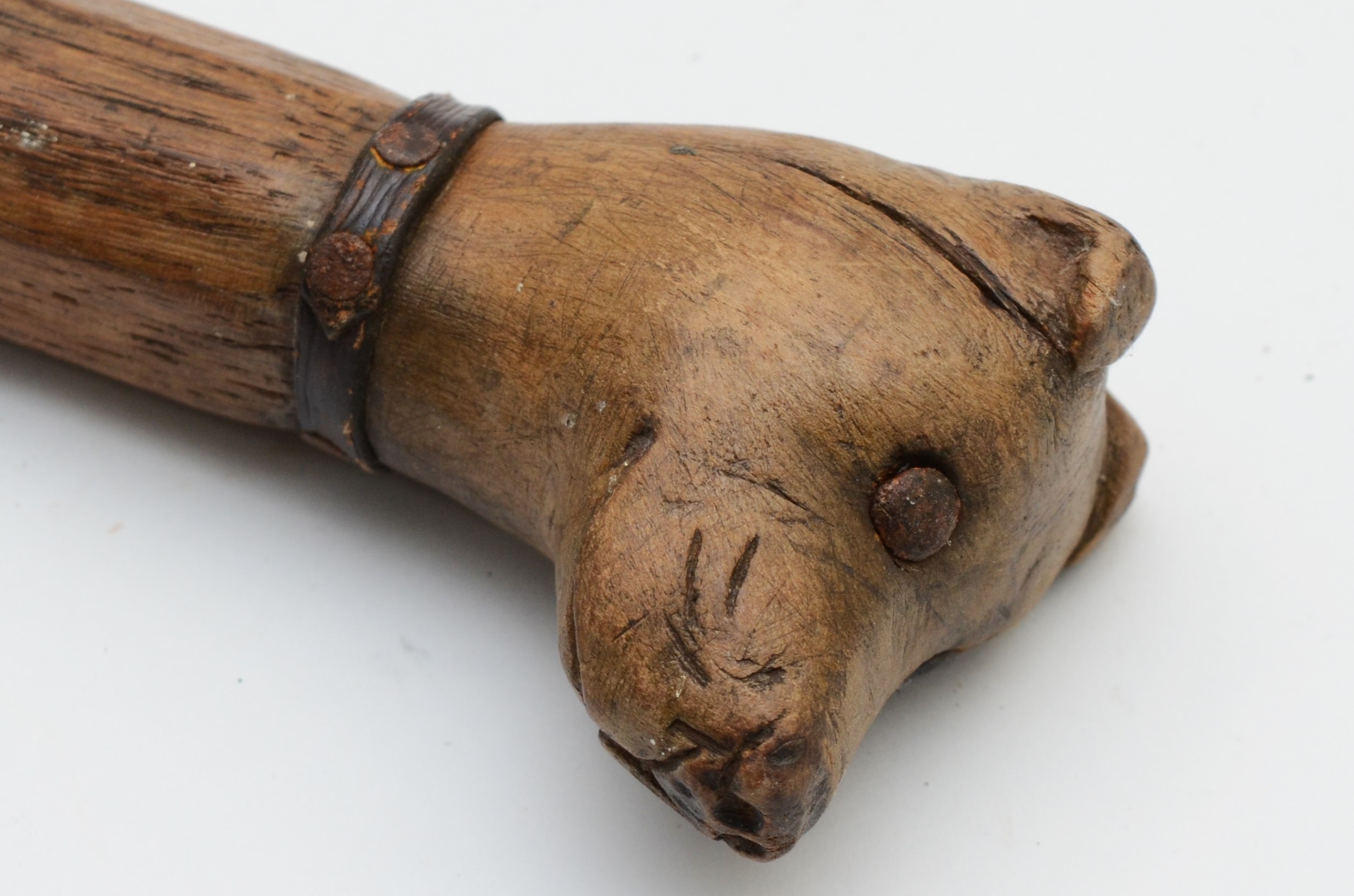 A late 19th century carved fruitwood walking stick, the carved dogs head terminal with glass bead - Image 6 of 6