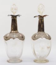 An Edwardian silver mounted pair of spirit decanters, by William Hutton & Sons Ltd., Birmingham