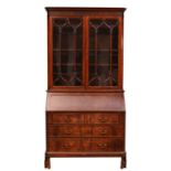 A George III mahogany bureau bookcase, moulded dentil carved cornice over two astragal glazed doors,