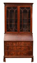 A George III mahogany bureau bookcase, moulded dentil carved cornice over two astragal glazed doors,