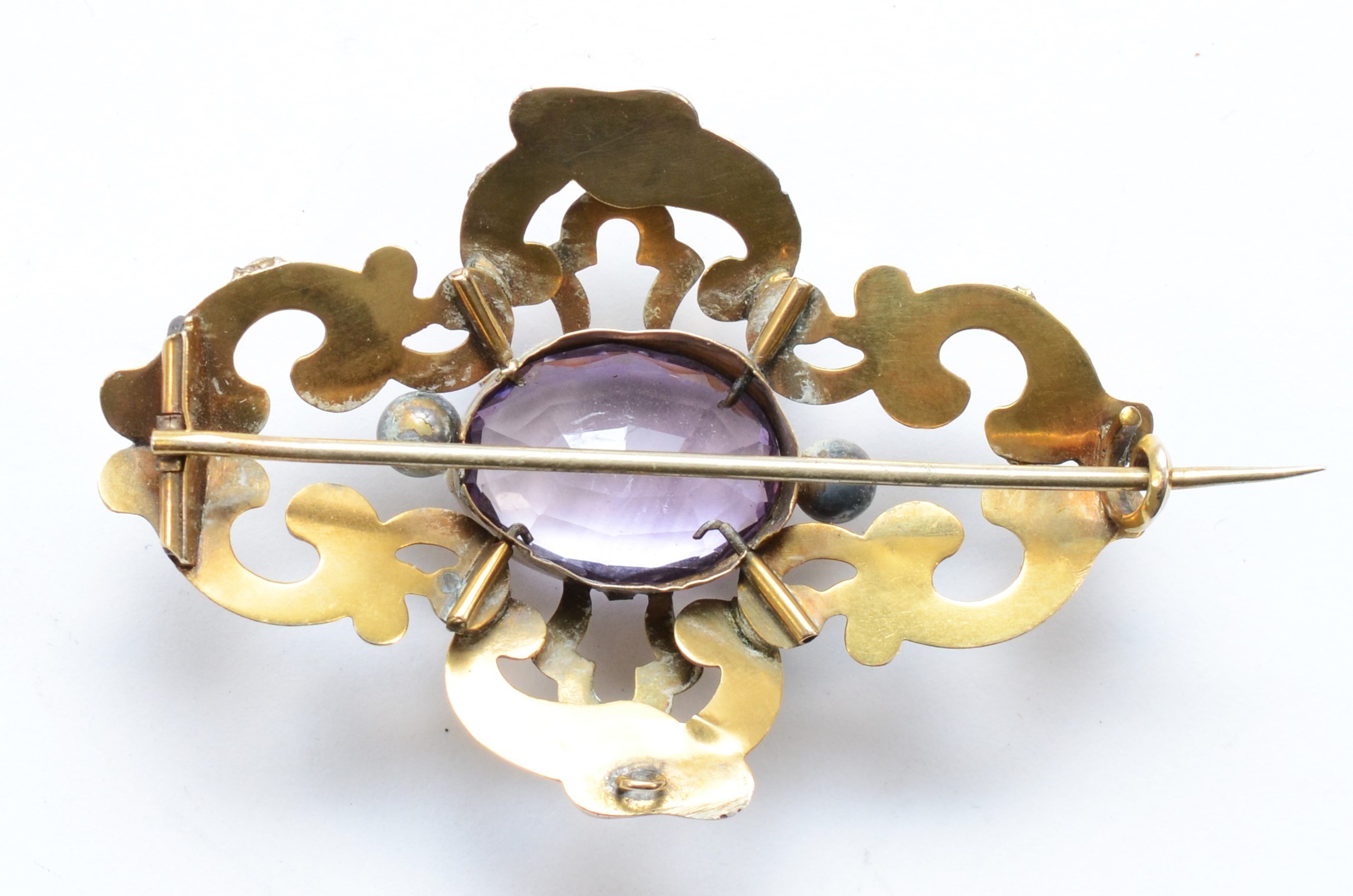 A Victorian unmarked gold and amethyst brooch, with chased foliate scroll frame, 60 x 40mm, 12gm. - Image 2 of 2