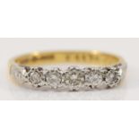 An 18ct gold and platinum vintage five stone diamond ring, claw set with graduated brilliant cut