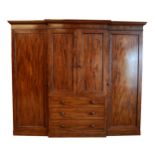 A George III flame mahogany triple breakfront wardrobe, circa late 19th century, dentil moulded