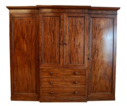 A George III flame mahogany triple breakfront wardrobe, circa late 19th century, dentil moulded