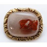 A Georgian unmarked gold and agate mounted brooch, the frame with carved shells and flowers, 28 x