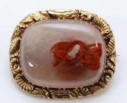 A Georgian unmarked gold and agate mounted brooch, the frame with carved shells and flowers, 28 x