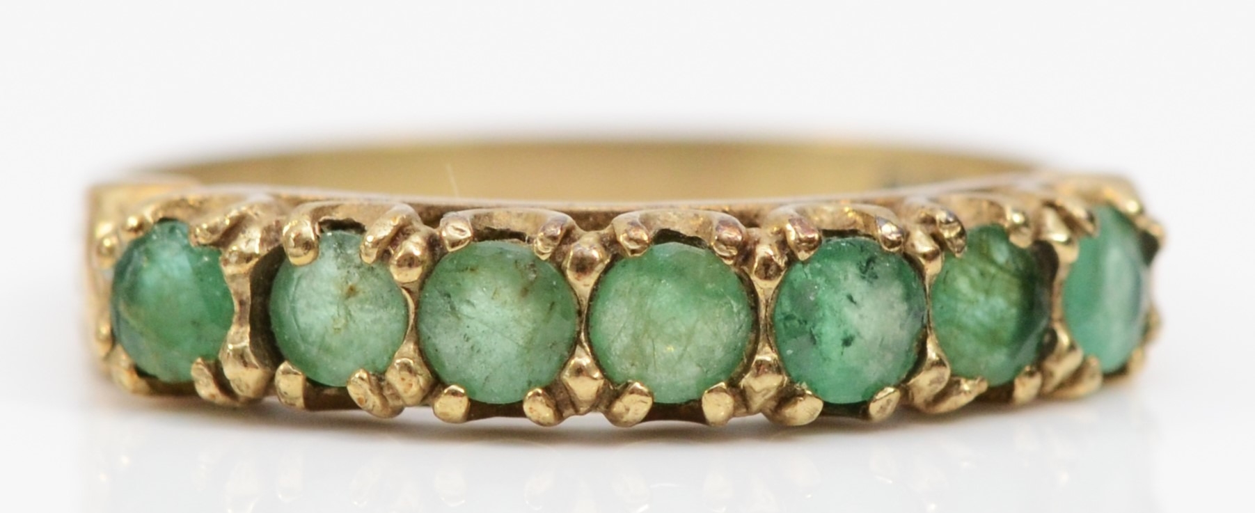 A 9ct gold and emerald half eternity ring, R, 2.1gm