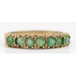 A 9ct gold and emerald half eternity ring, R, 2.1gm