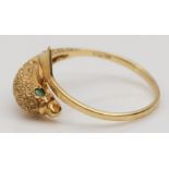 A 9ct gold textured dolphin ring, emerald set eyes, N, 1.6gm