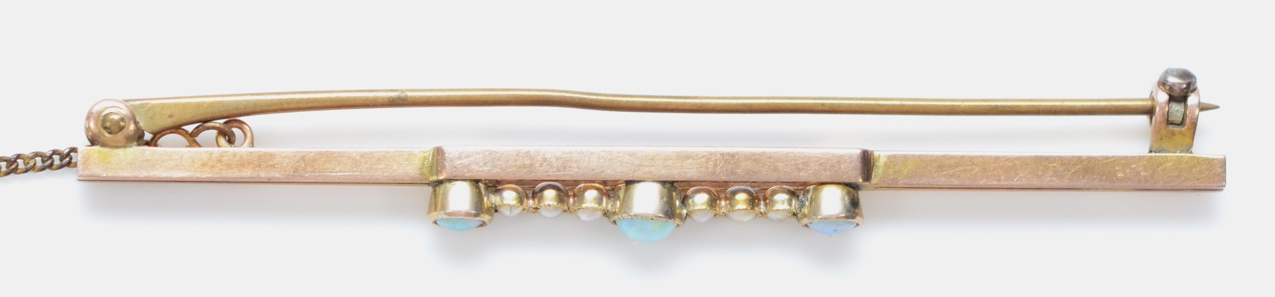 An Edwardian 9ct gold bar brooch, milligrain collet set with three opal, half pearls between, - Image 2 of 2