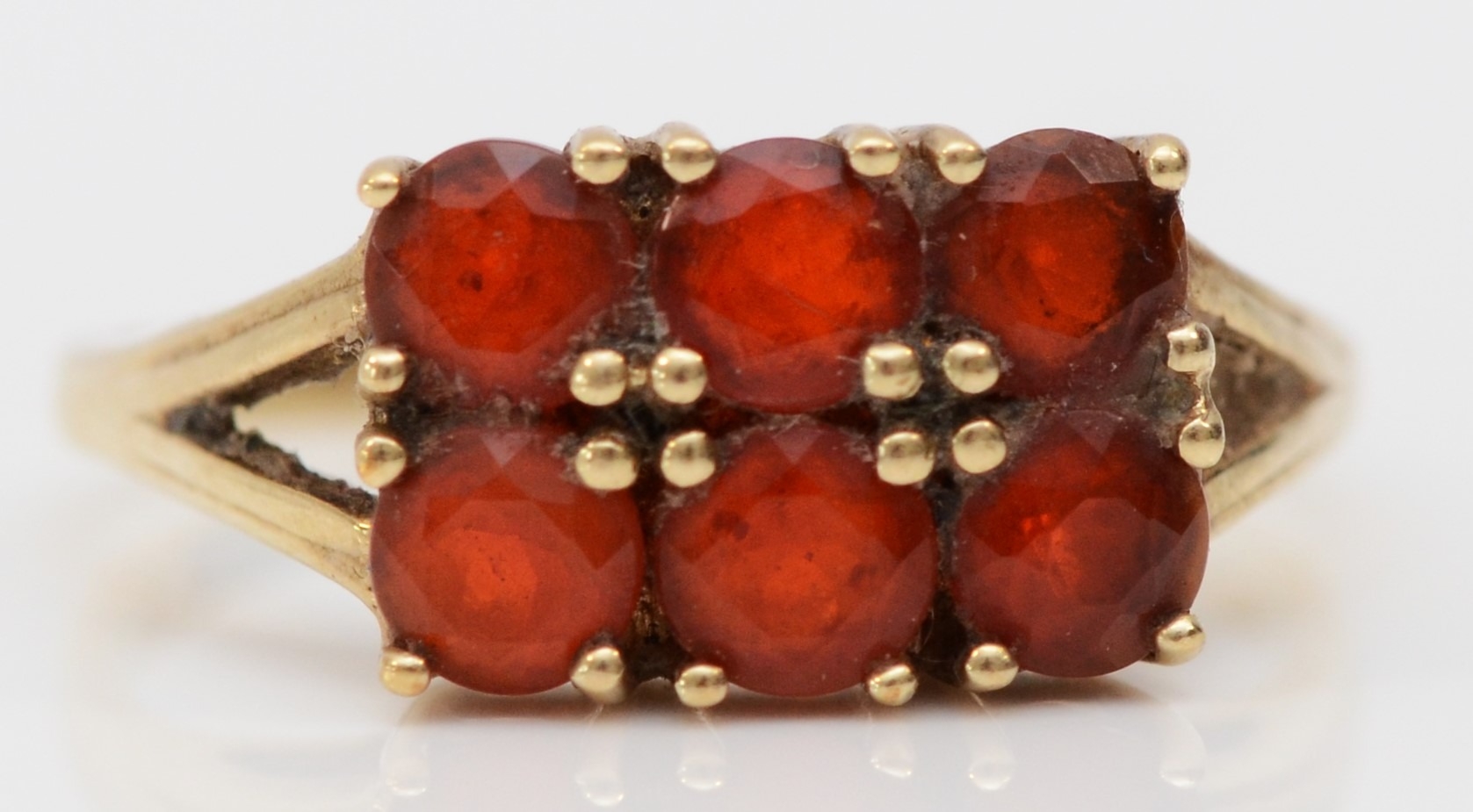 A 9ct gold and six orange gemstone ring, N 1/2, 2.4gm