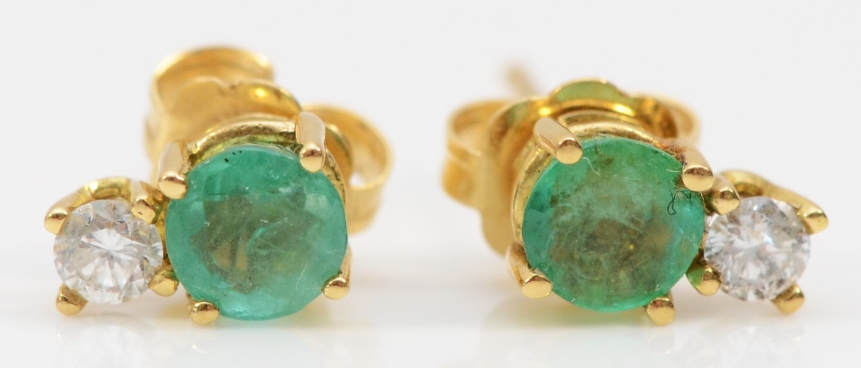 An 18ct gold pair of emerald and brilliant cut diamond pair of ear studs, 0.8gm