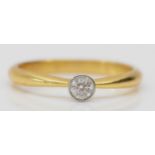 An 18ct gold collet set brilliant cut diamond single stone ring, approximately 0.15cts, L, 2.4gm