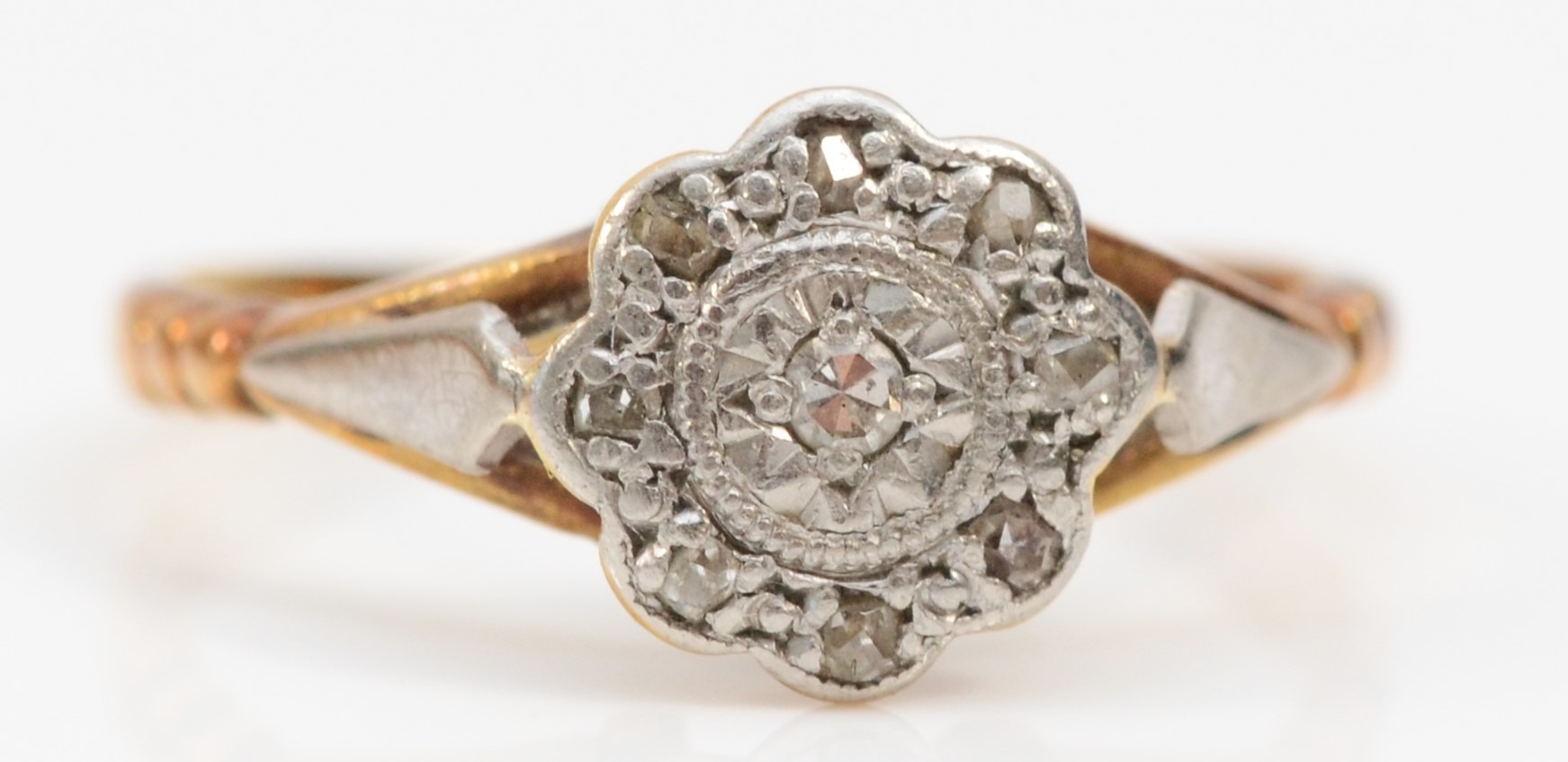 An Art Deco 18ct gold and platinum diamond set ring, J 1/2, 2.3gm