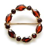 A 9ct gold and garnet hoop brooch, diameter 24mm, 2.6gm