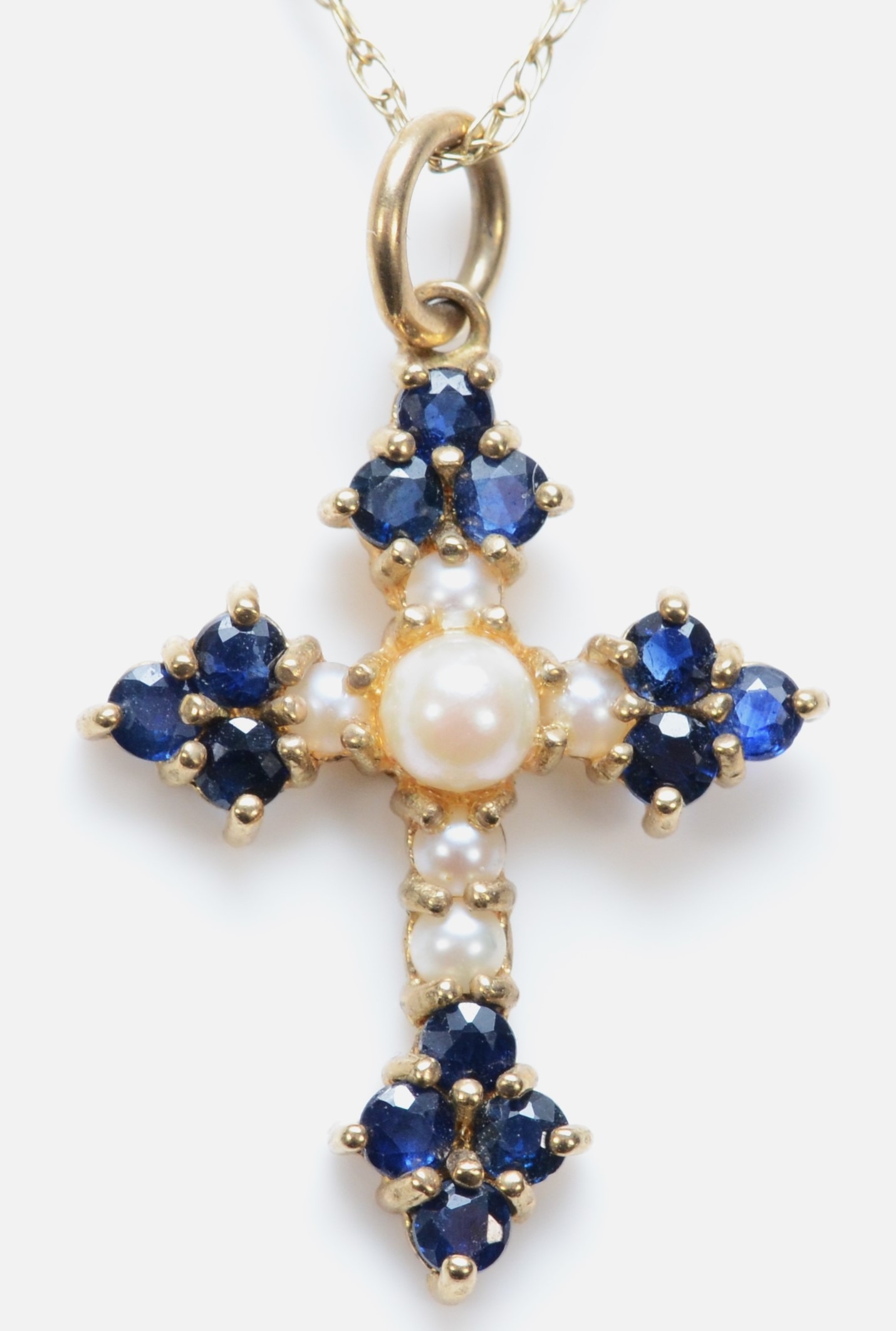 A 9ct gold sapphire and cultured pearl cross pendant, 22 x 17mm, chain, 2.3gm