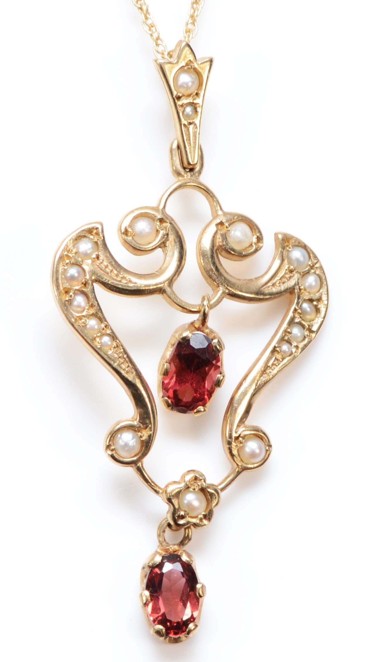 A Victorian style 9ct gold garnet and half pearl set openwork pendant, 40mm, chain, 3.4gm