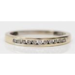 A 9ct white gold and brilliant cut diamond channel set ring, N, 1.6gm