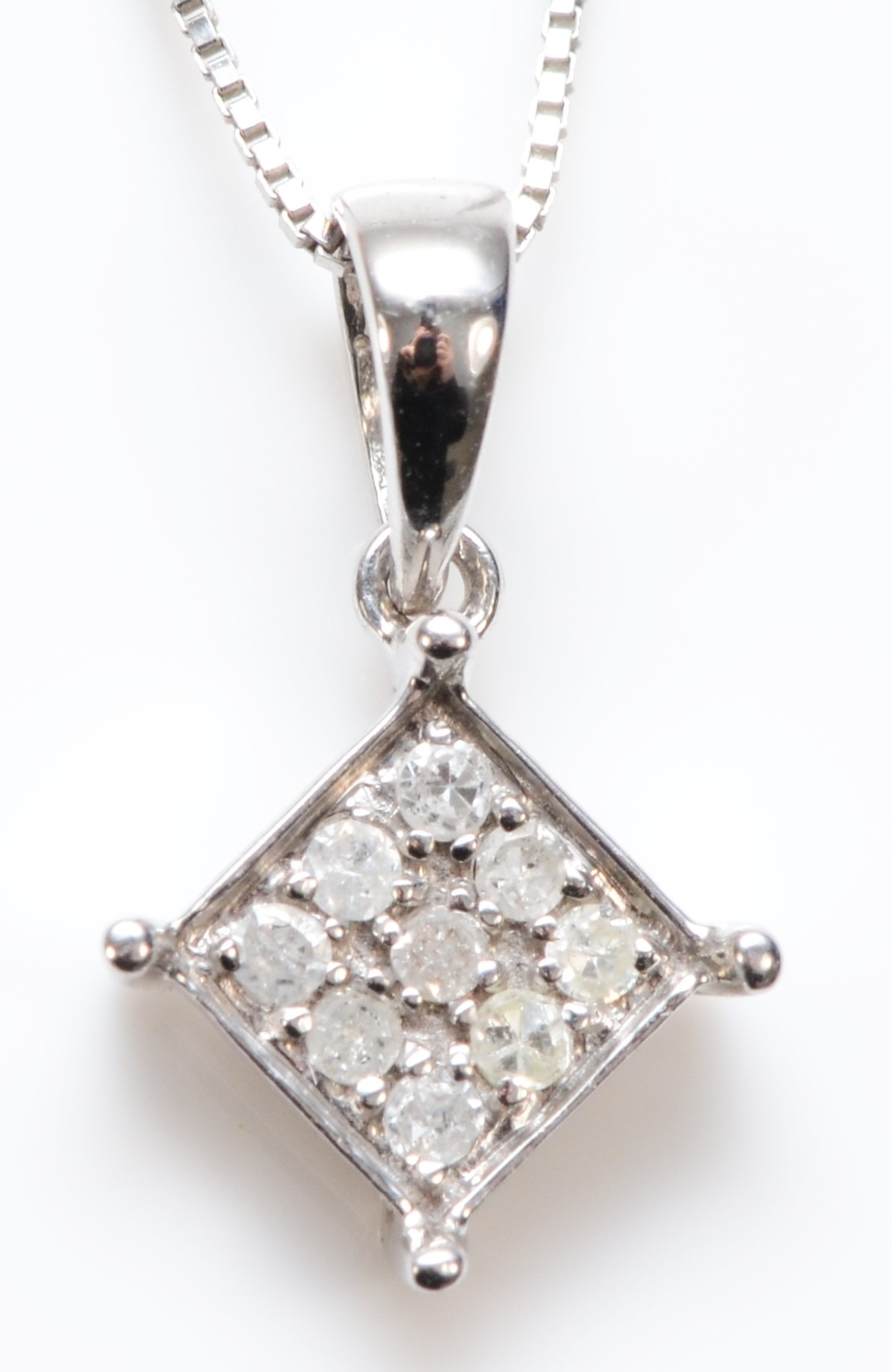 A 9ct white gold and diamond set pendant, 5 x 5mm, chain, 1.4gm