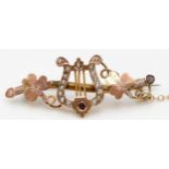 A Victorian 9ct rose gold red stone and half pearl harp and clover leaf brooch, Birmingham 1892,