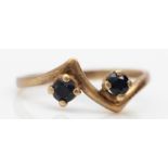 A 9ct gold and two stone sapphire ring, H, 1gm