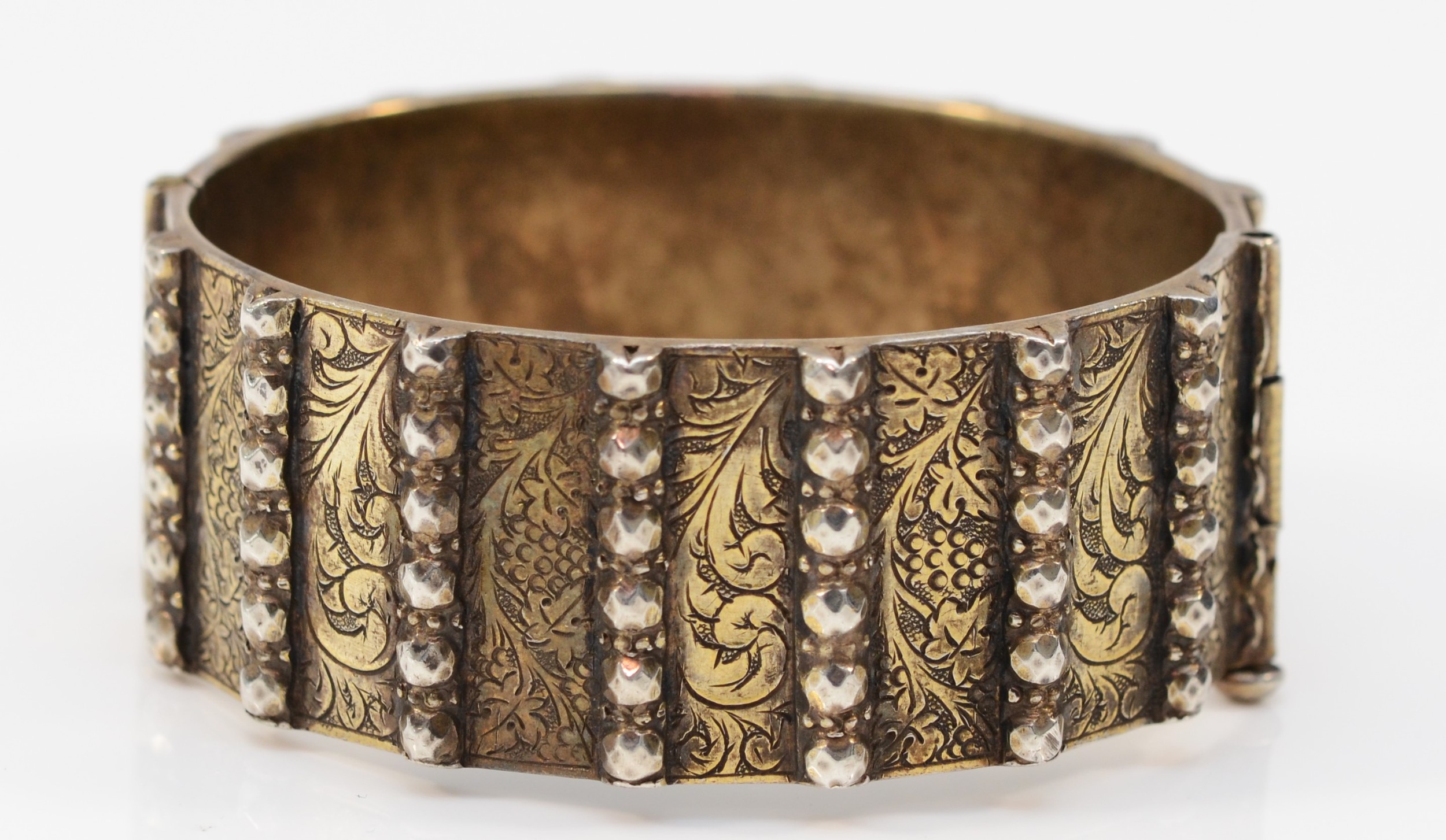 A heavy unmarked silver gilt hinged bangle, with slide clasp, 58 x 53mm, 90gm