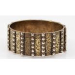 A heavy unmarked silver gilt hinged bangle, with slide clasp, 58 x 53mm, 90gm