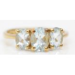 A 9ct gold three stone aquamarine ring, S 1/2, 2.7gm