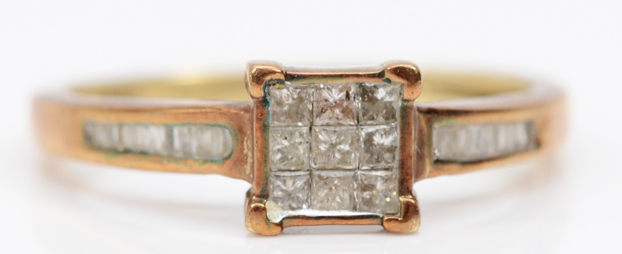 A 9ct gold and diamond dress ring, set with nine Princess cut stones, baguette cut shoulders, N, 2gm