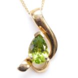 A 9ct gold and peridot abstract pendant, 20mm, chain, 3.3gm