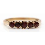 A 9ct gold and five stone garnet ring, R, 2.1gm