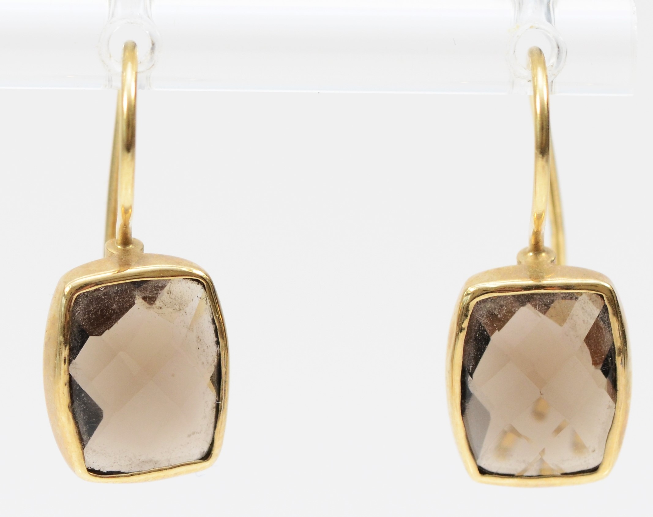 A 9ct gold mounted pair of multi facetted smokey quartz ear rings, stones 10 x 8mm, 2.1gm