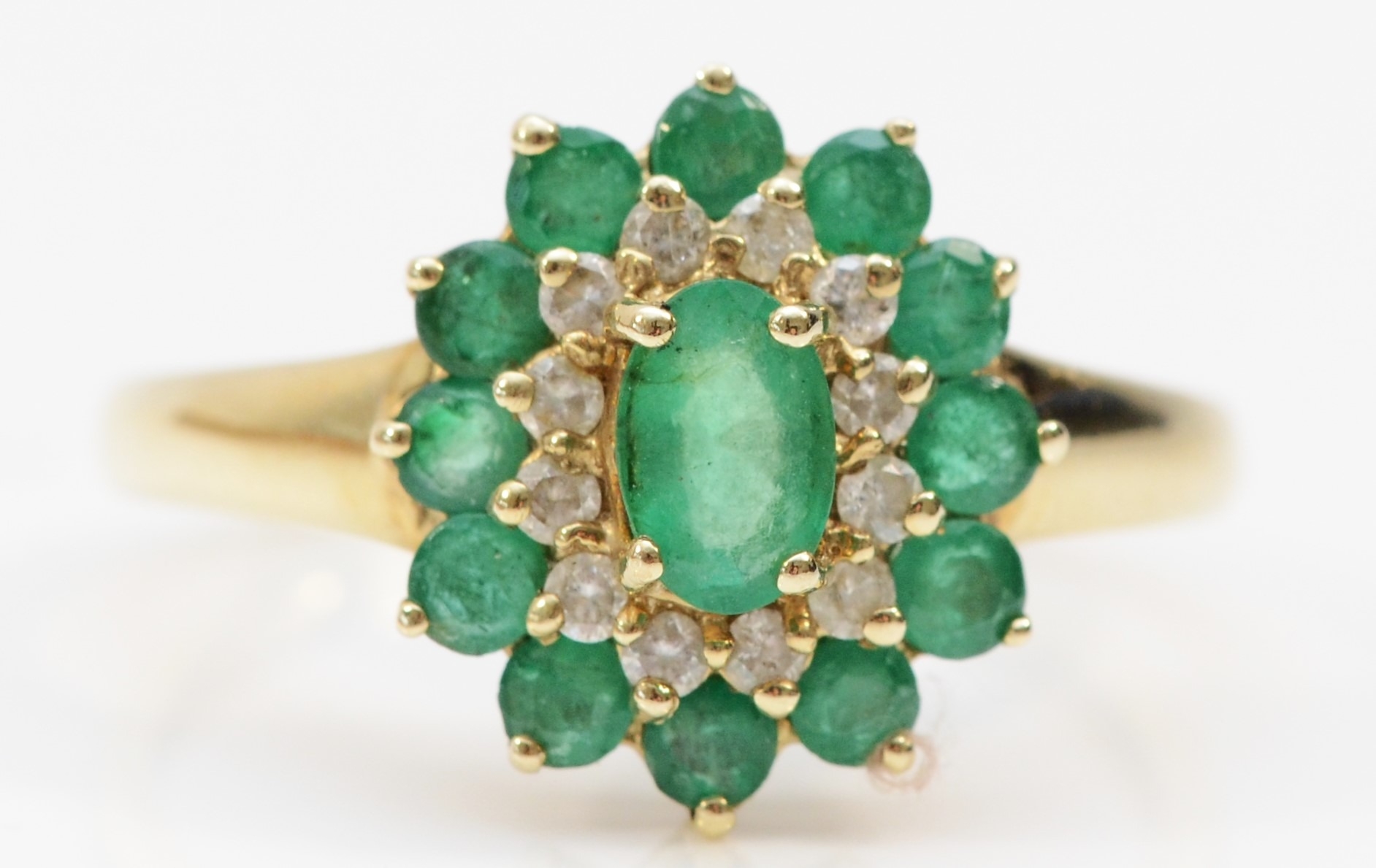 A 9ct gold emerald and brilliant diamond cluster ring, R, 2.4gm