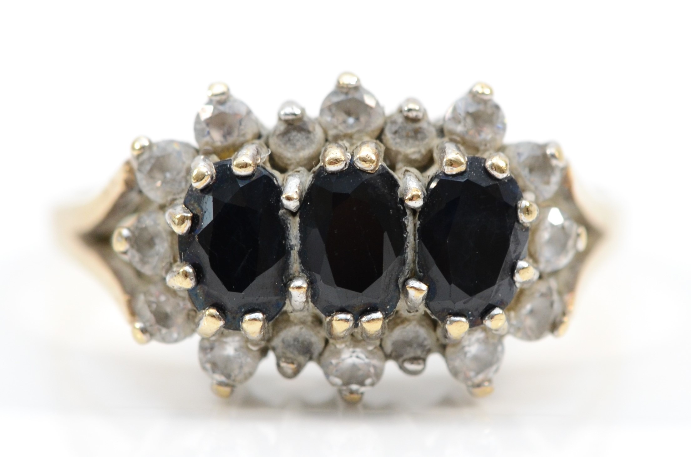 A 9ct gold three stone sapphire and white stone dress ring, T, 3.4gm.