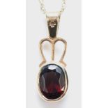 A 9ct gold and garnet pendant, Millennium mark, 21mm overall, chain, 2.2gm