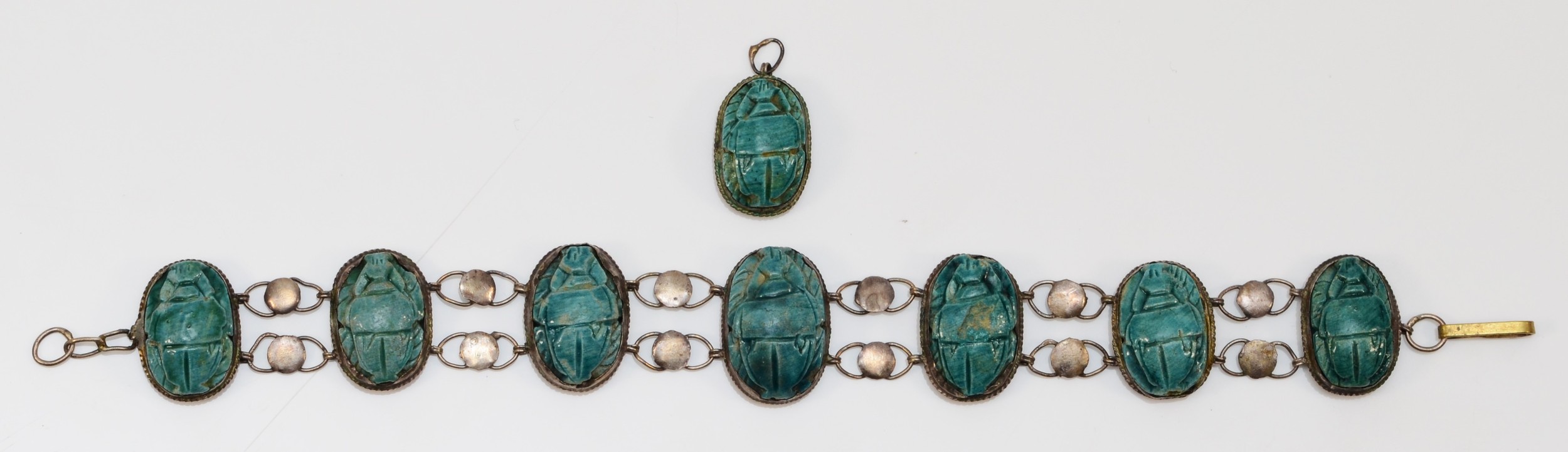 A low grade silver and faience scarab beetle bracelet, 17cm, together with a matching pendant.