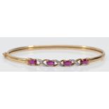 A 9ct gold ruby and diamond bangle, 60 x 50mm, 4.7gm