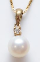 A 9ct gold diamond and 5mm cultured pearl pendant, chain, 1.5gm