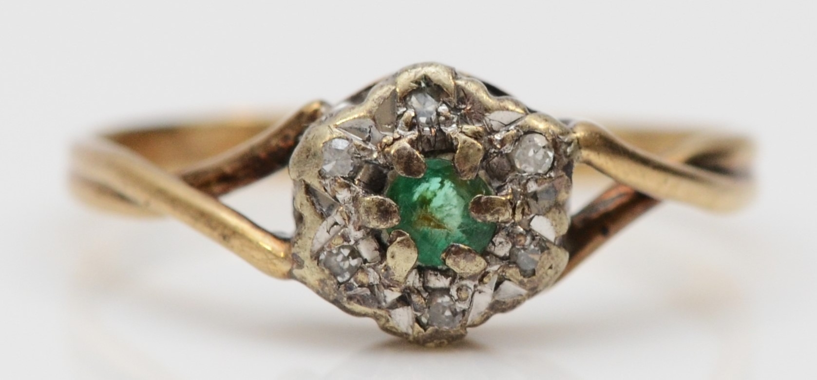 A 9ct gold emerald and diamond cluster ring, J, 1.3gm