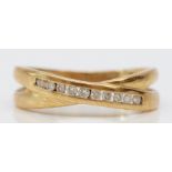 A 9ct gold and brilliant cut diamond cross over ring, stated weight 0.15ct,O 1/2, 2.4gm