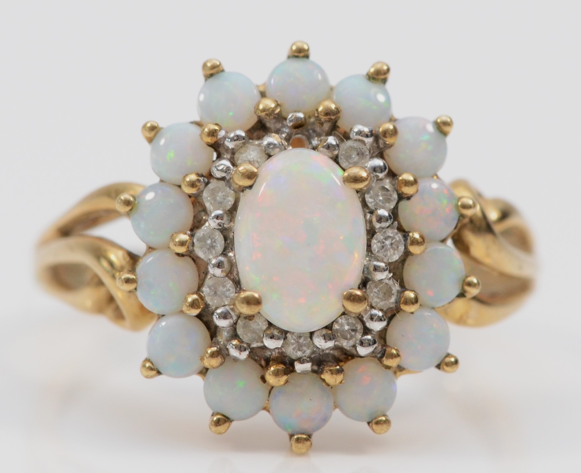 A 9ct gold opal and brilliant cut diamond cluster ring, one diamond vacant, 15 x 13mm, O, 3gm