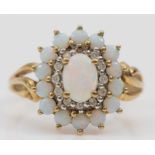 A 9ct gold opal and brilliant cut diamond cluster ring, one diamond vacant, 15 x 13mm, O, 3gm