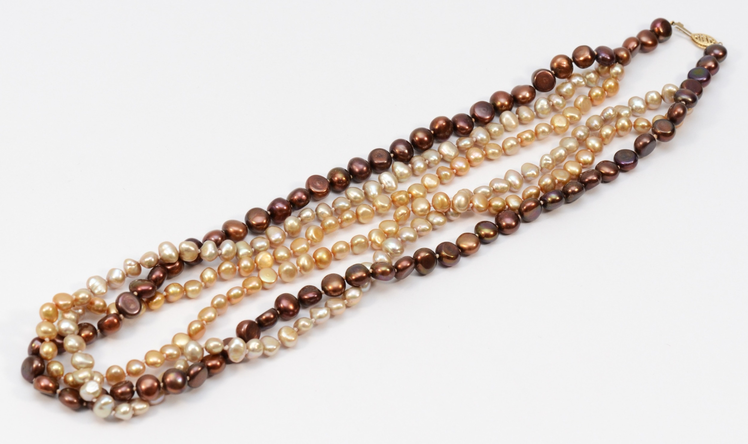 A three row baroque coloured cultured pearl twist necklace, 59cm.