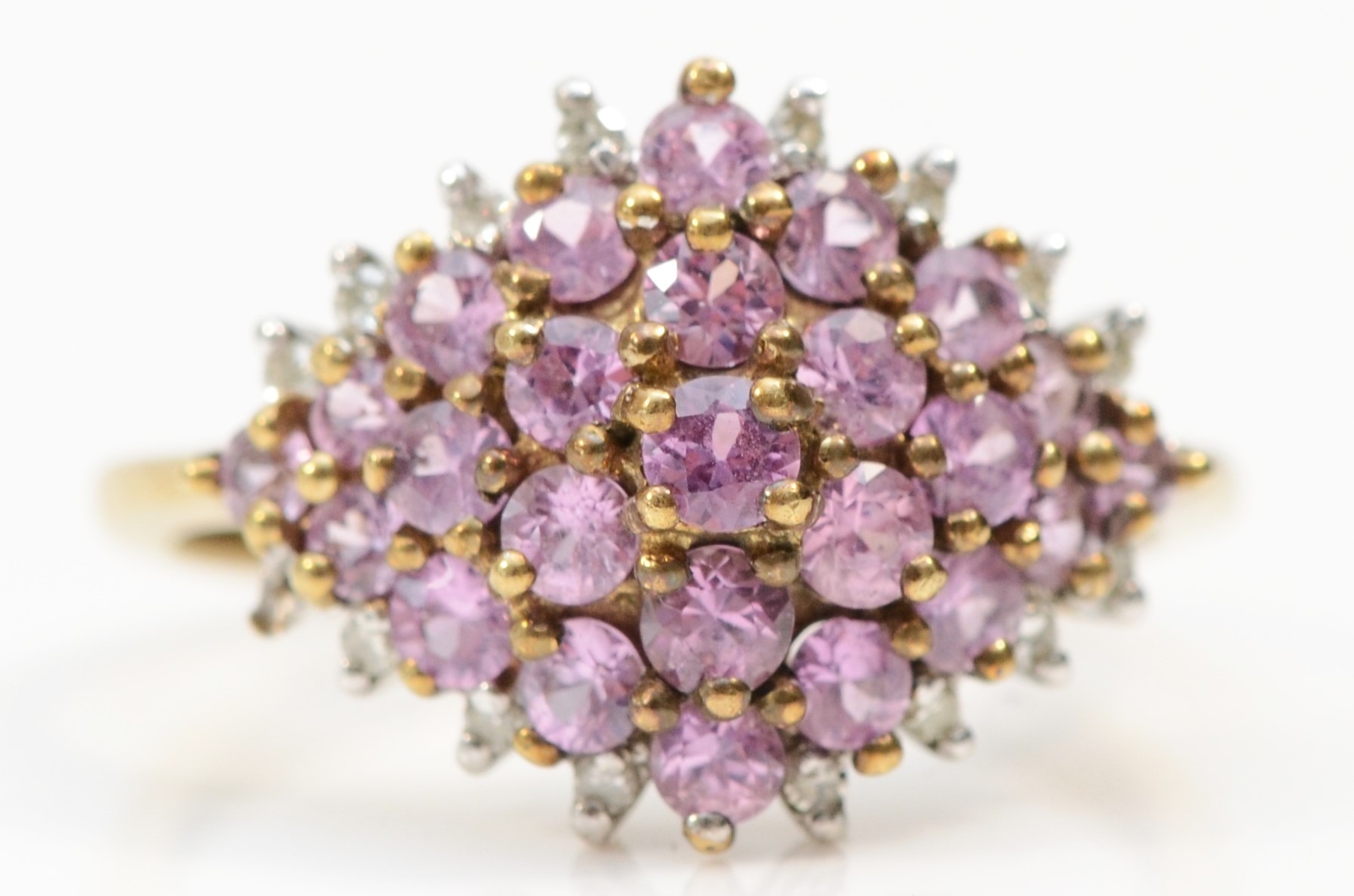 A 9ct gold pink sapphire and diamond cluster ring, O, 2.8gm