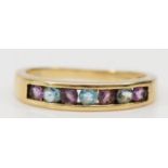 A 9ct gold, amethyst and topaz channel set ring, J 1/2, 1.6gm