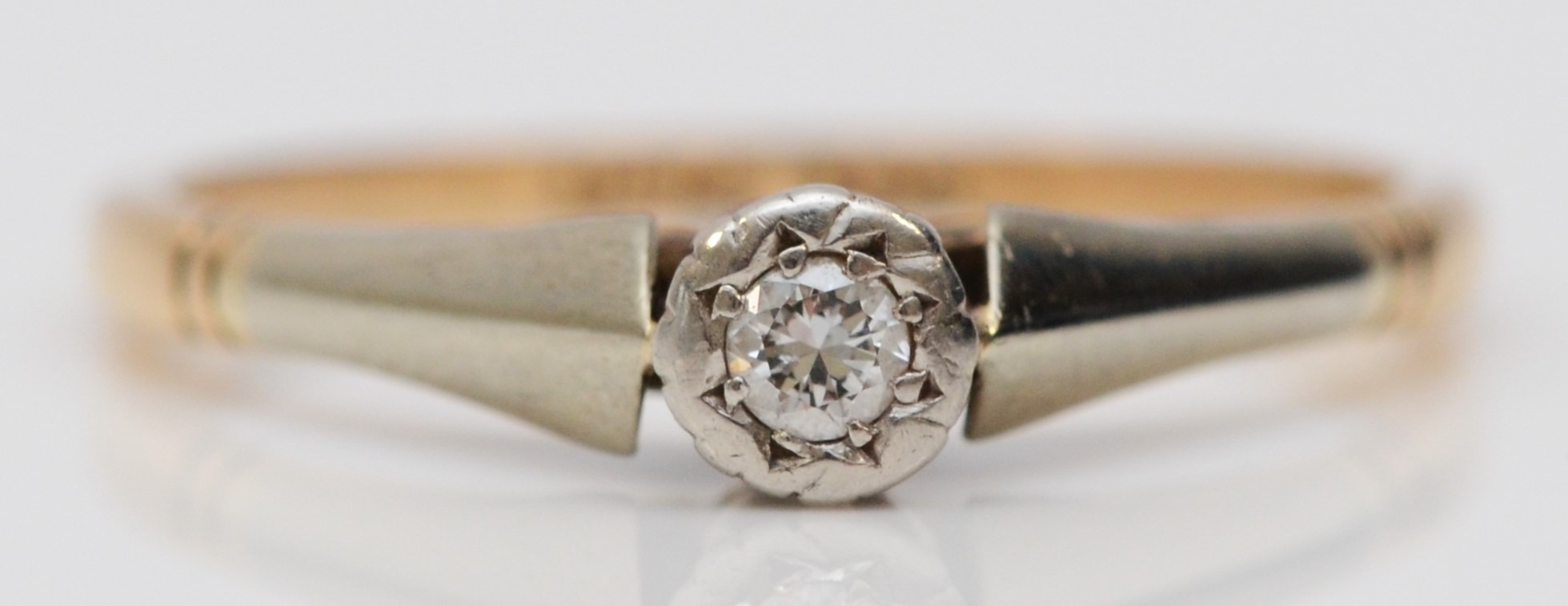 A vintage 9ct gold and platinum brilliant cut diamond single stone ring, M 1/2, 2gm