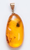 A 9ct gold mounted amber pendant, stone 37 x 20mm
