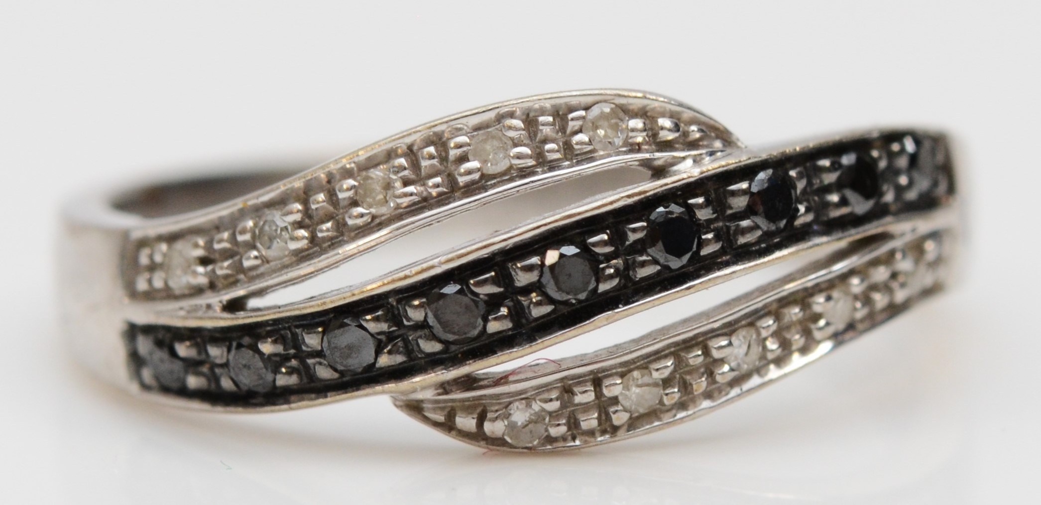 A 9ct white gold enhanced black diamond and diamond dress ring, P 1/2, 2.5gm