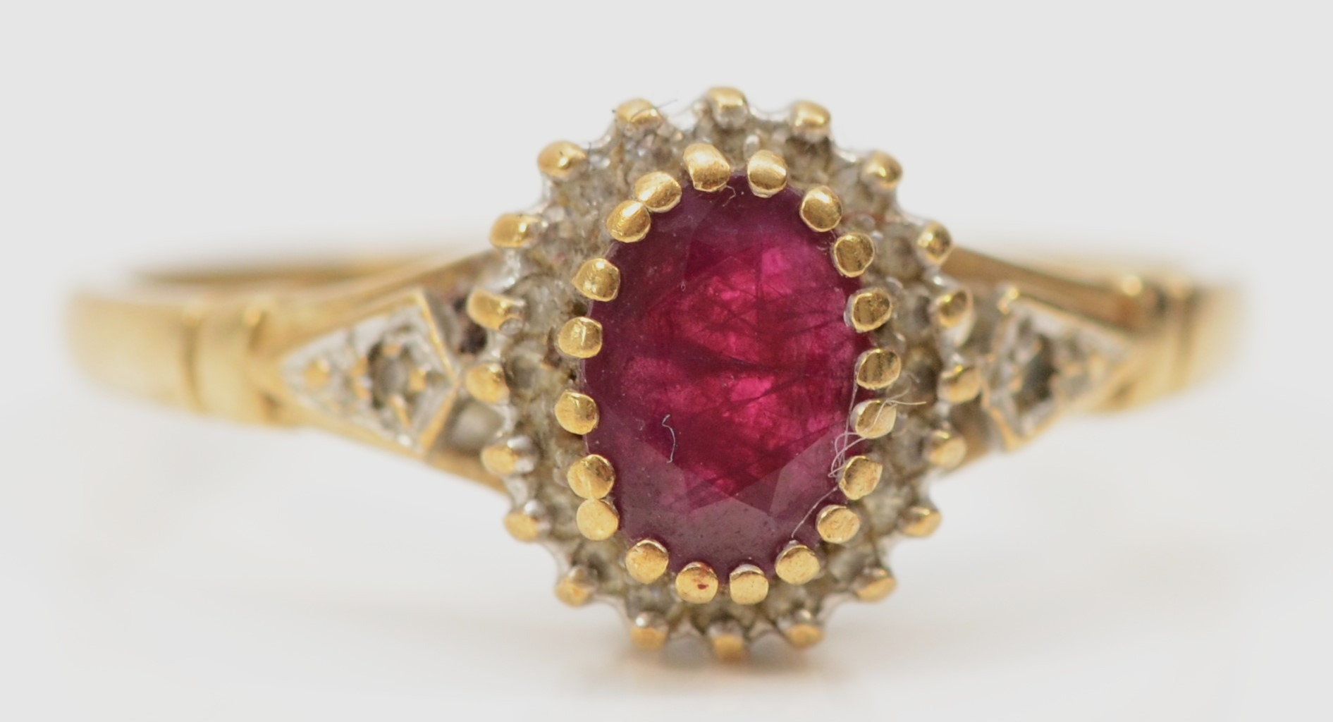 A 9ct gold ruby and diamond cluster ring, S, 2.4gm
